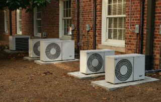 Commercial AC units sitting outside a multi-home building.